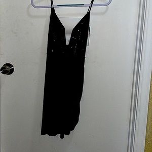 Short Black sequin dress with adjustable straps and low cut neckline. Never worn